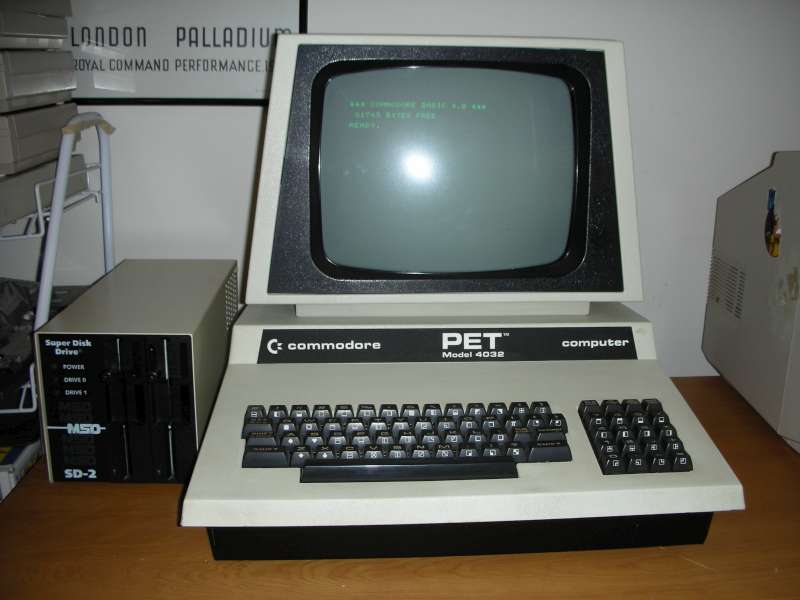 Commodore PET 4032 on a desk with green phosphor monitor glowing